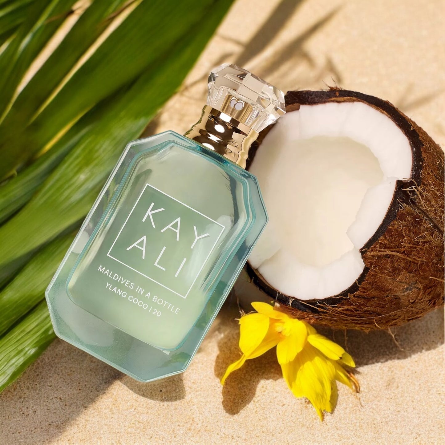 Fragrance decant styled with tropical fruits and glowing sunlight on a sandy backdrop.