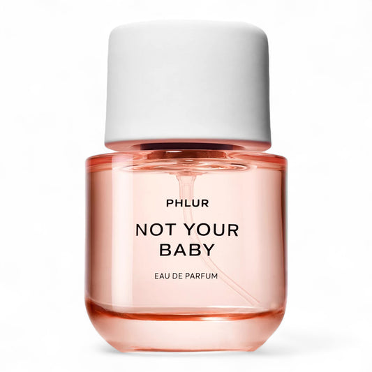 A decant of Phlur Not Your Baby, a floral spicy fragrance with cardamom, violet, and vanilla milk, available in perfume samples.