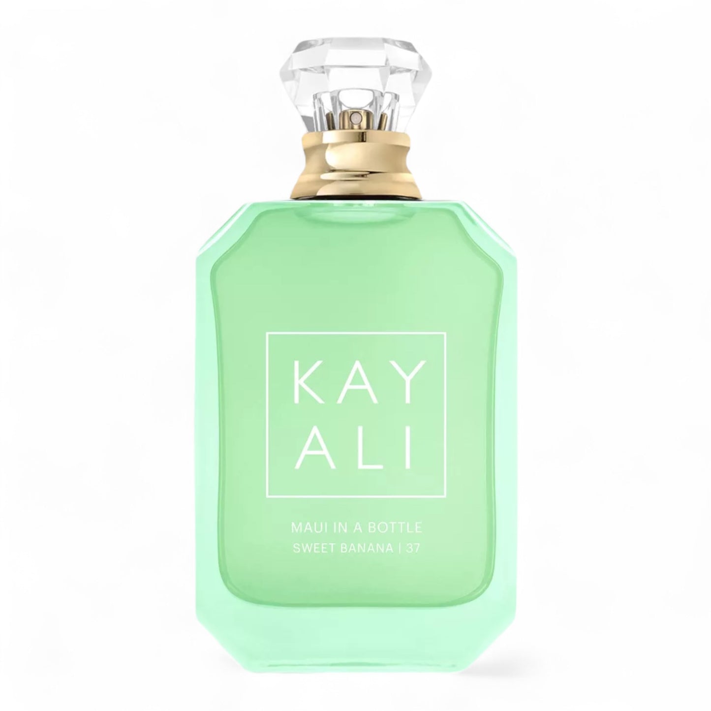 Kayali Maui in a Bottle Sweet Banana | 37 sample surrounded by banana slices, coconut shells, and tropical flowers on a sandy backdrop.