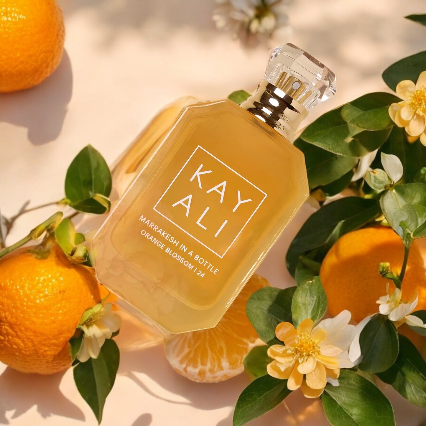 Fragrance decant styled on a textured rug with warm spices, wood, and golden sunset lighting.