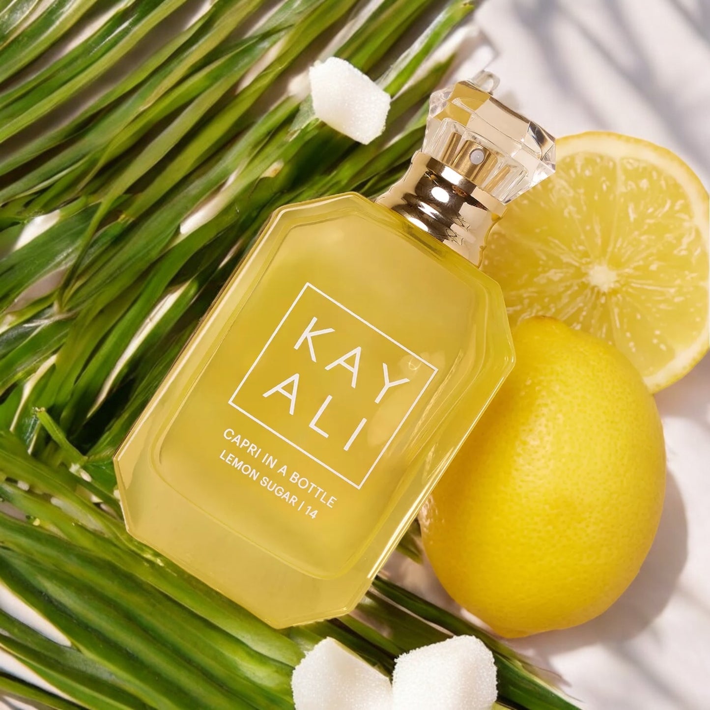 Decant of Lemon Sugar with a seaside view and citrus blossoms, evoking a sunny Italian escape.