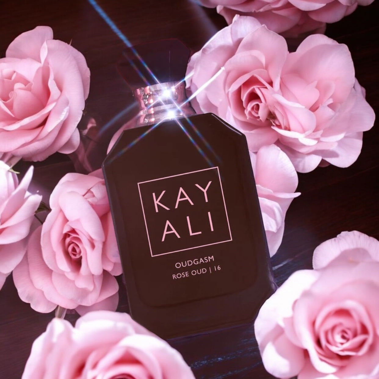 Close-up of Oudgasm Rose Oud perfume sample, showing notes of Bulgarian rose, oud, and warm vanilla in an intense floral-woody blend.