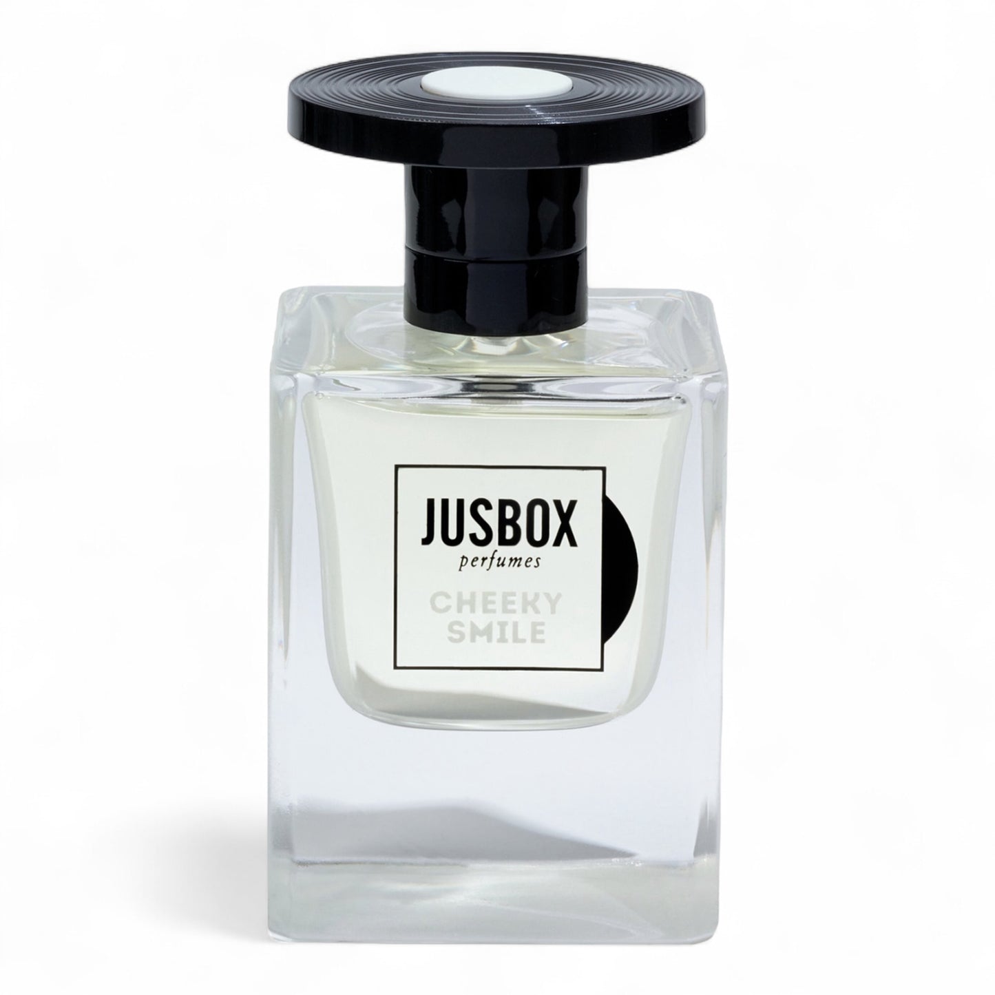 A sample of Jusbox Cheeky Smile, a modern ambery-woody scent built on Iso E Super, Ambroxan, and Cashmeran, available in decants and testers.