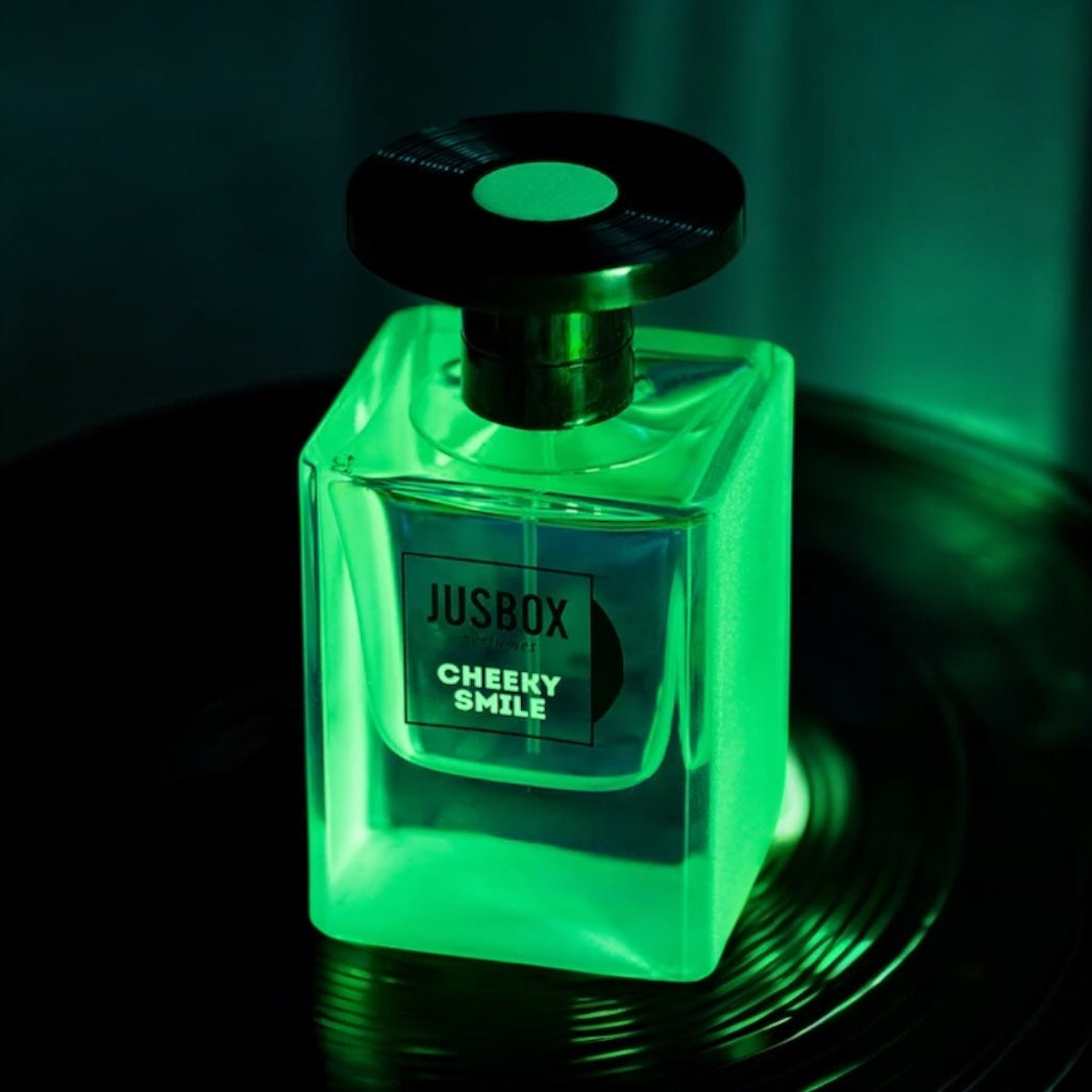 Close-up of a Cheeky Smile perfume sample, featuring synthetic amber molecules and warm wood notes inspired by Acid House culture.