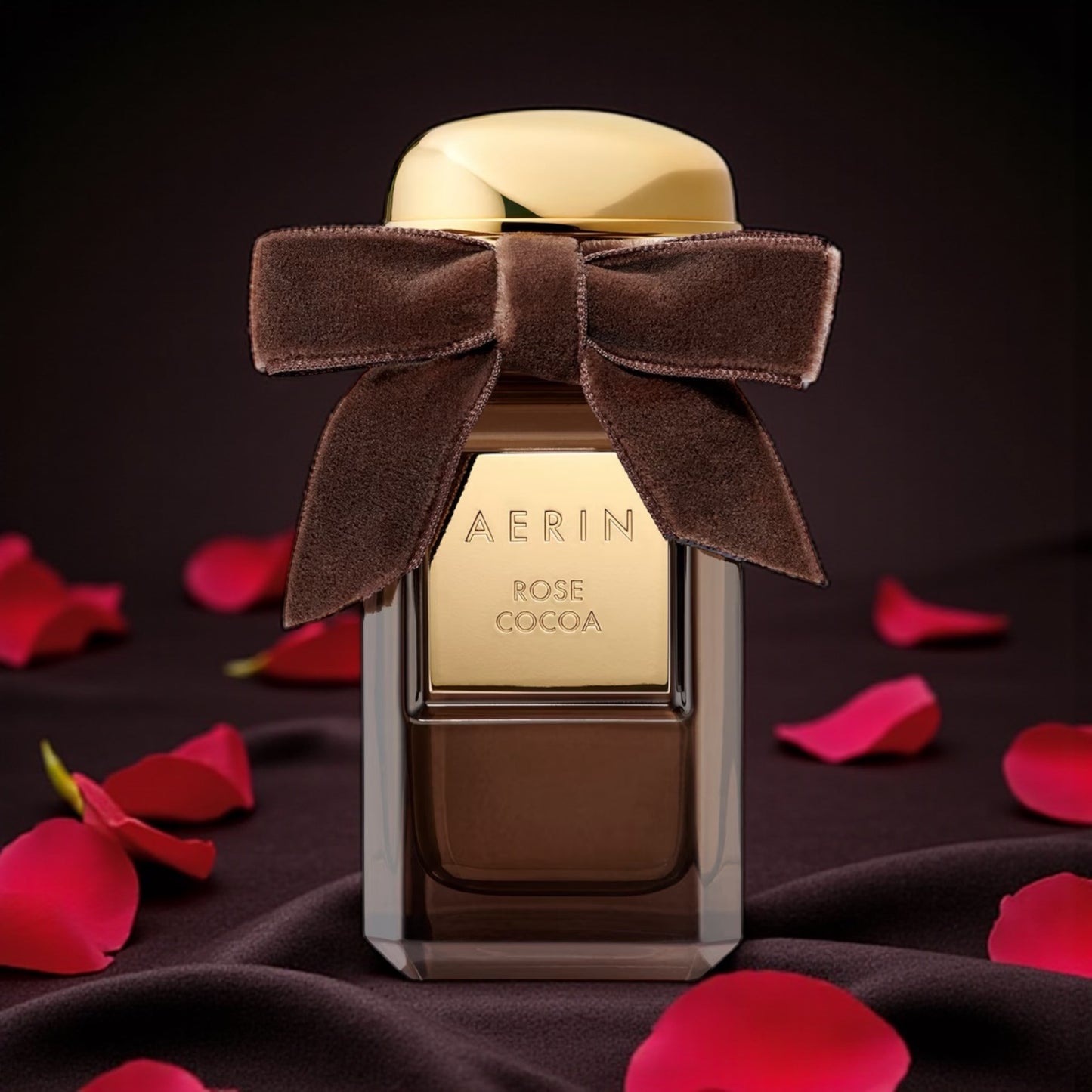 Aerin Rose Cocoa perfume sample – rose, cocoa bean, and vanilla notes in a warm chocolate-toned setting with golden light.