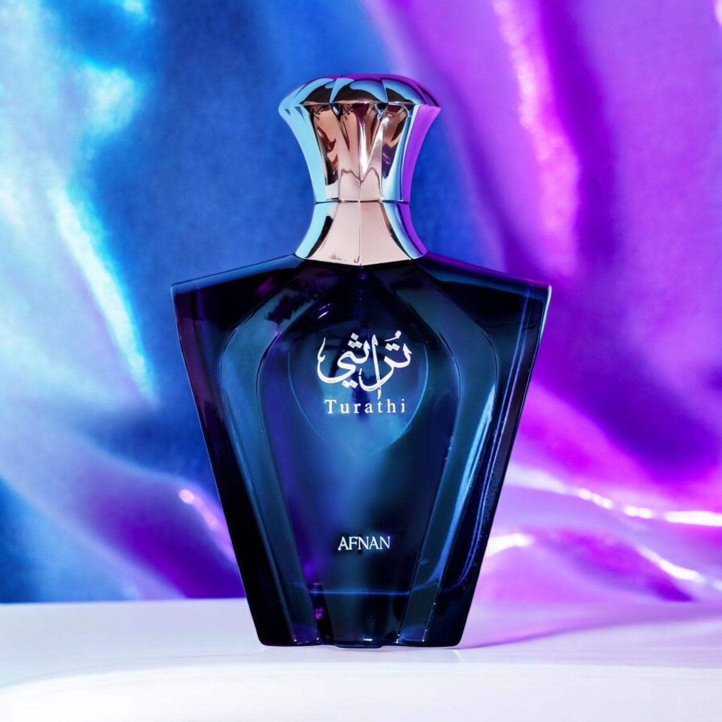 Afnan Turathi Blue perfume sample - fresh citrus and woody amber perfume styled in an irridescent setting.