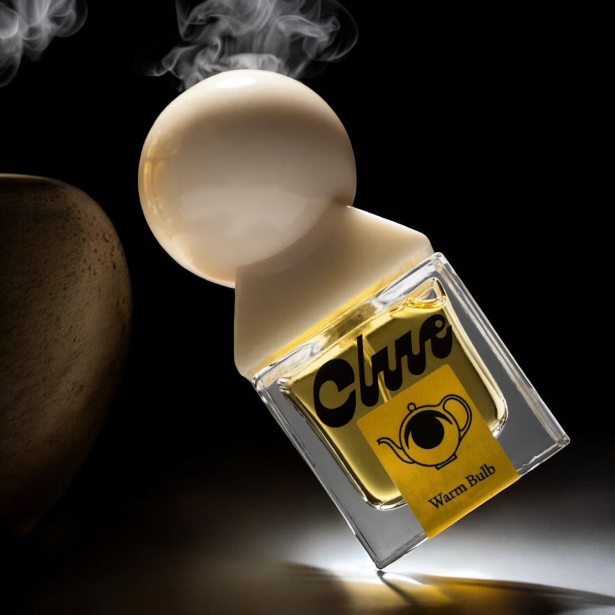 Clue Warm Bulb perfume sample - ambient scent styled with yellow lighting, old books and soft textures