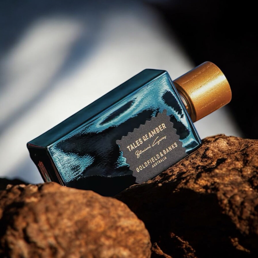 Goldfield & Banks Tales of Amber perfume sample - elegant ambergris and orris scent in a warm, sophisticated setting.