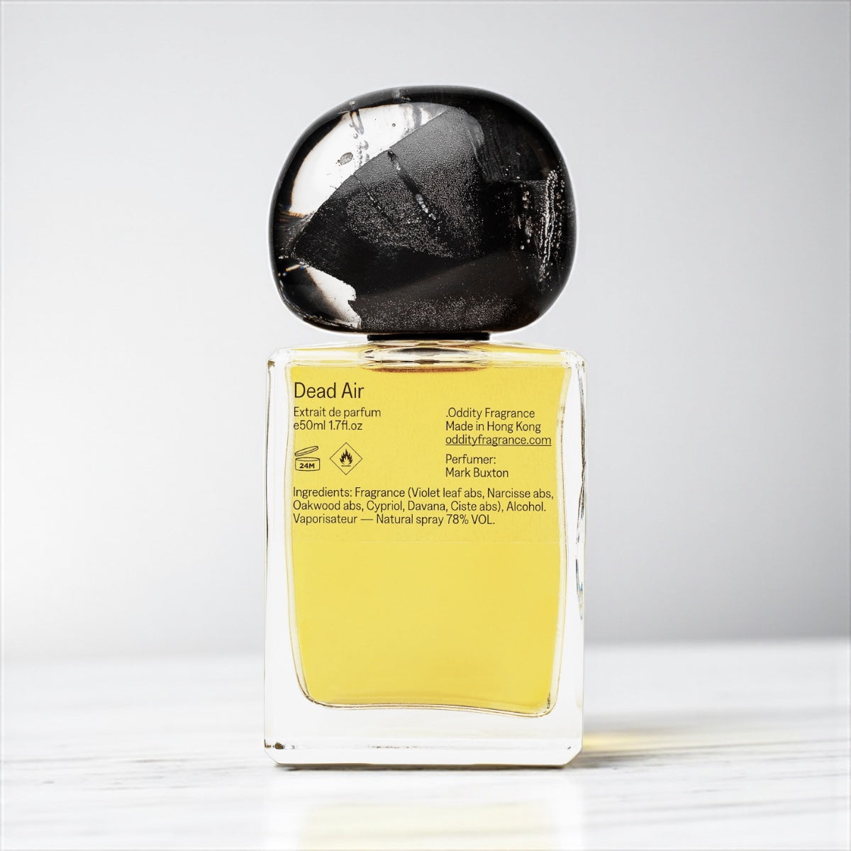 Oddity Dead Air perfume sample – violet leaf, salt, and smoky resin notes styled in a dark, marine-inspired setting.