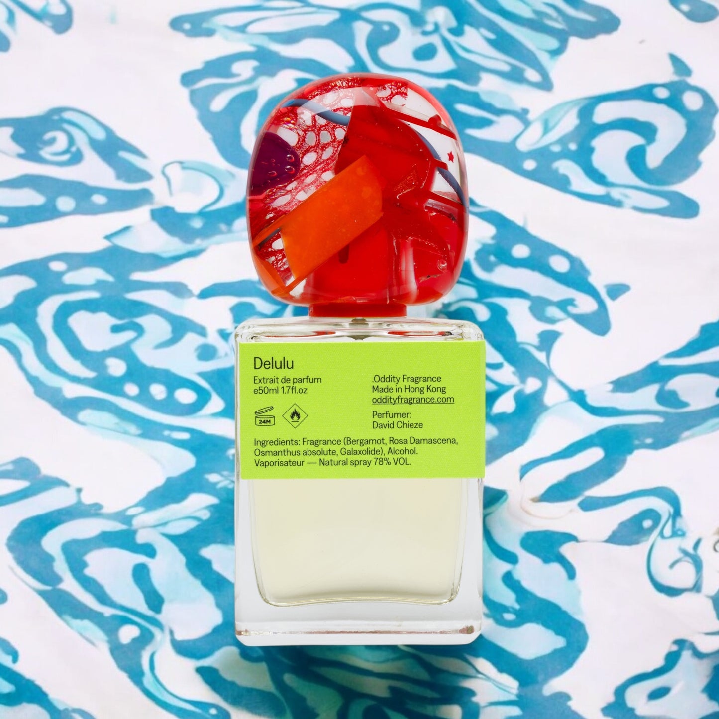 Oddity Delulu perfume sample - fruity rhubarb and berry scent in a playful, sunlit summer setting.
