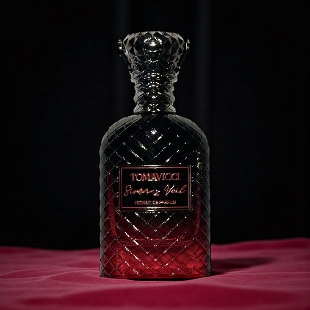 Tomavicci Siren’s Veil perfume sample – spiced plum, tobacco and amber wood notes styled in a moody dark-toned setting.