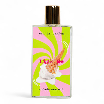 Michela Mezzetti Lick Me fragrance sample bottle surrounded by notes of whipped cream, waffle cone, and vanilla, evoking a creamy dessert.