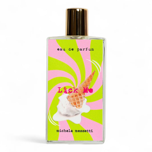 Michela Mezzetti Lick Me fragrance sample bottle surrounded by notes of whipped cream, waffle cone, and vanilla, evoking a creamy dessert.