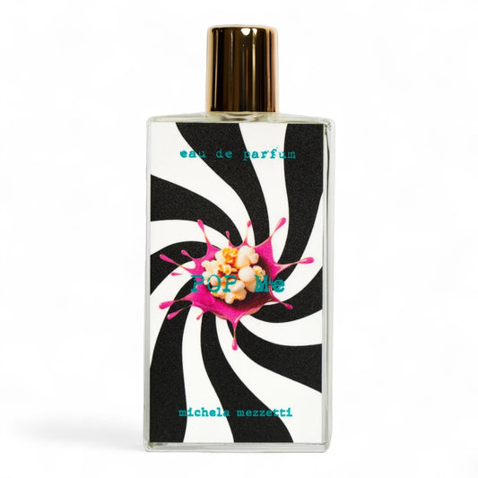 Michela Mezzetti Pop Me sample bottle with popcorn, pink icing, and cotton candy to evoke a playful gourmand mood.