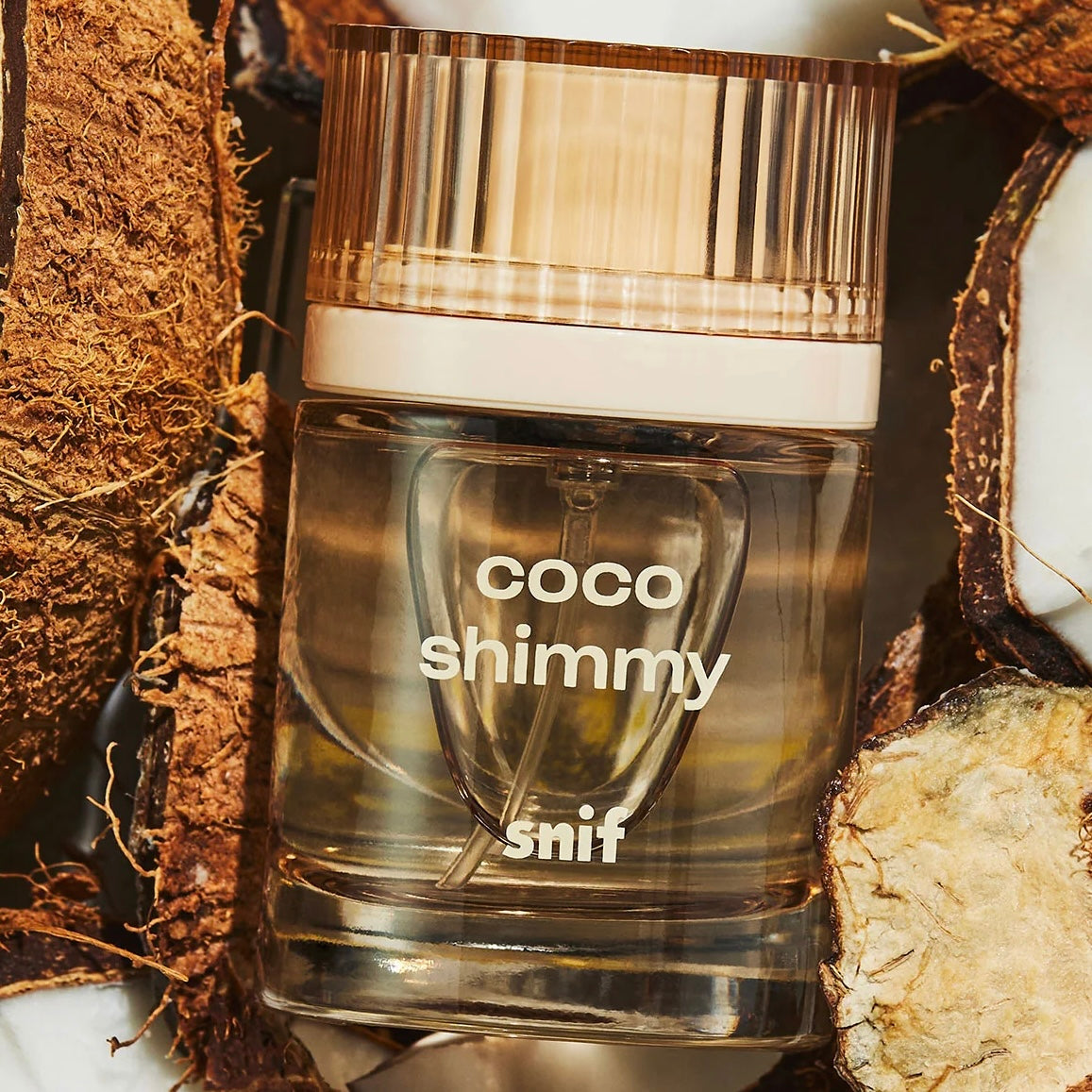 Close-up of a fragrance sample of Coco Shimmy, highlighting its creamy, sun-kissed, and beachy notes for a laid-back summer scent