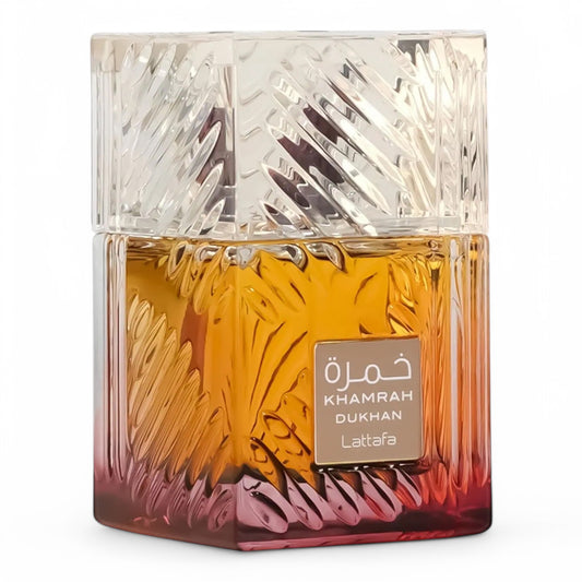 A decant of Lattafa Khamrah Dukhan, an intense smoky amber fragrance with tobacco, incense, and spiced praline, available in perfume samples.
