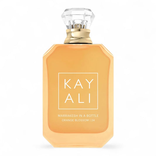 Kayali Marrakesh in a Bottle Orange Blossom | 24 sample surrounded by orange blossoms, rose petals, and Moroccan lanterns.