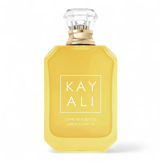Kayali Capri in a Bottle Lemon Sugar | 14 sample vial surrounded by fresh lemons, sugar crystals, and vanilla pods.