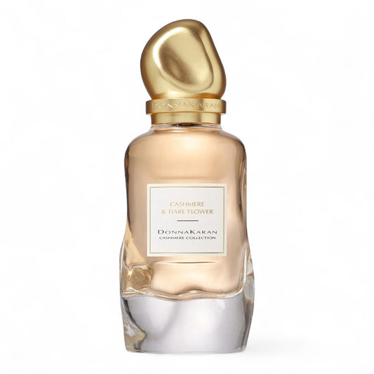 A sample of Donna Karan Cashmere & Tiare Flower, a solar floral fragrance with bergamot, creamy tiare flower, and warm vetiver, available in decants and testers.