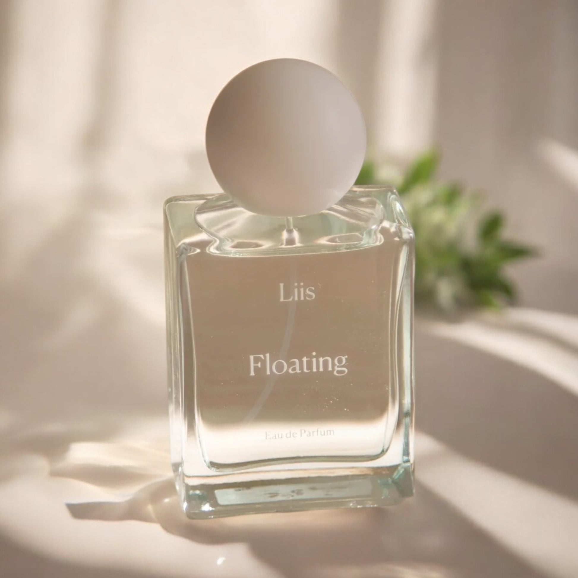 Close-up of a fragrance sample of Floating, highlighting its blend of juicy fruit, soft florals, and clean, woody notes for a serene, effortless scent.