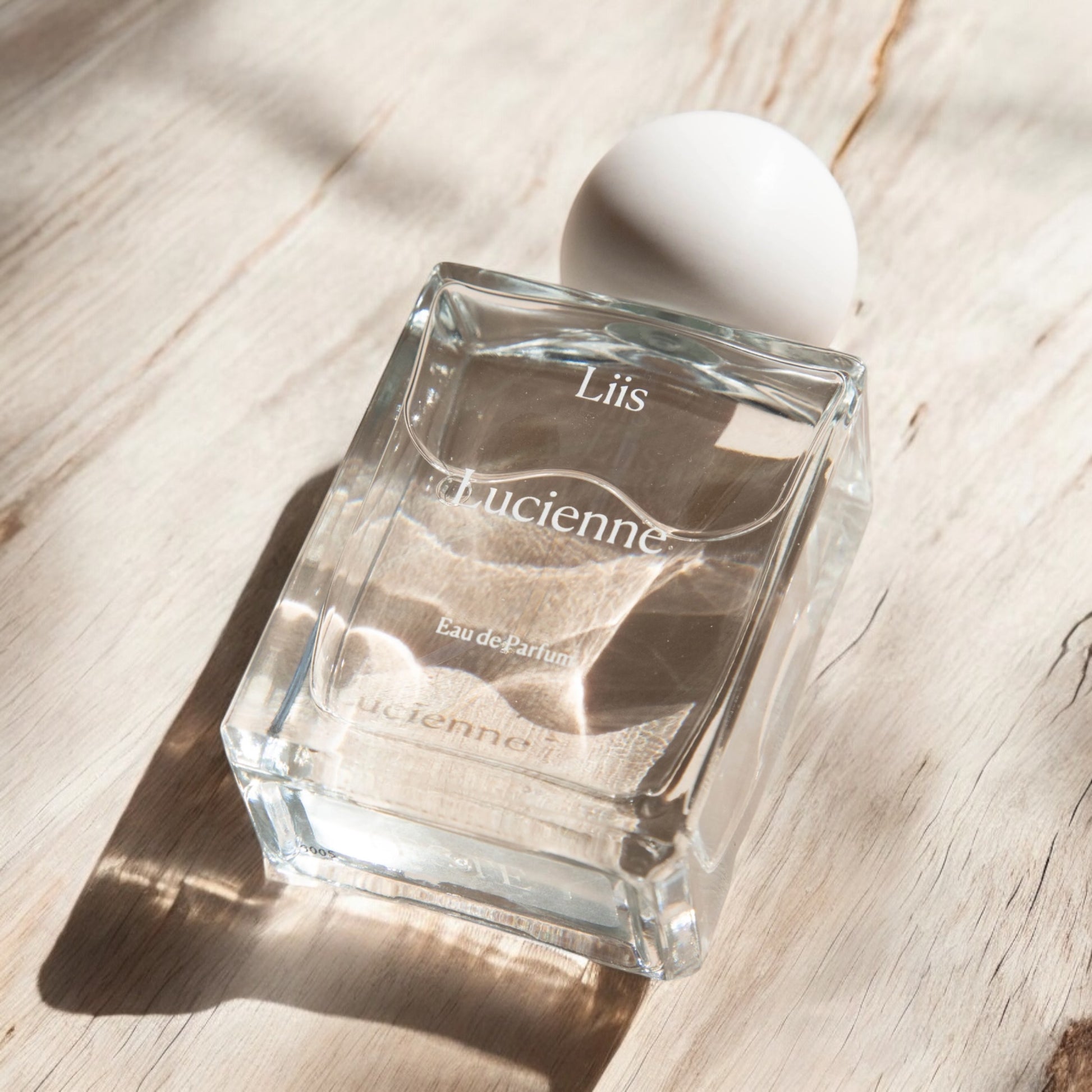 Close-up of a fragrance sample of Lucienne, highlighting its blend of bright citrus, airy florals, and salty marine notes for a crisp, radiant scent.