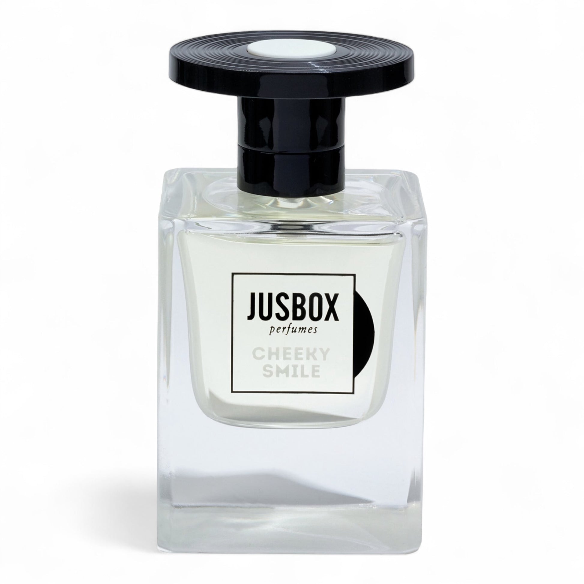 A sample of Jusbox Cheeky Smile, a modern ambery-woody scent built on Iso E Super, Ambroxan, and Cashmeran, available in decants and testers.