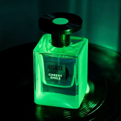 Close-up of a Cheeky Smile perfume sample, featuring synthetic amber molecules and warm wood notes inspired by Acid House culture.