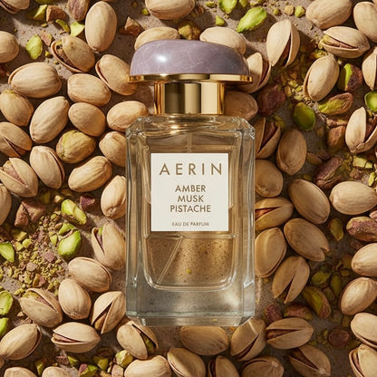 AERIN Amber Musk Pistache styled with pistachios