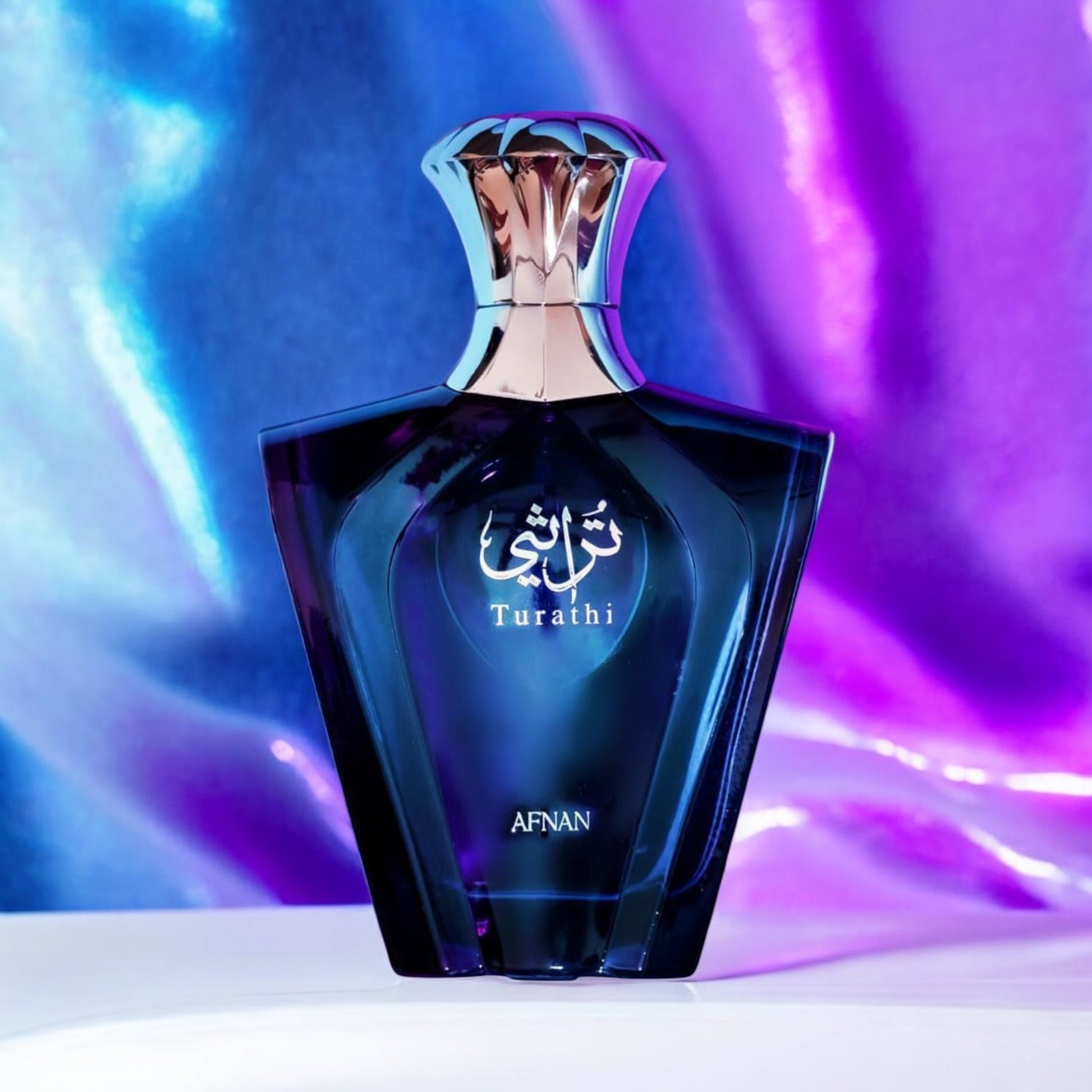 Afnan Turathi Blue perfume sample - fresh citrus and woody amber perfume styled in an irridescent setting.