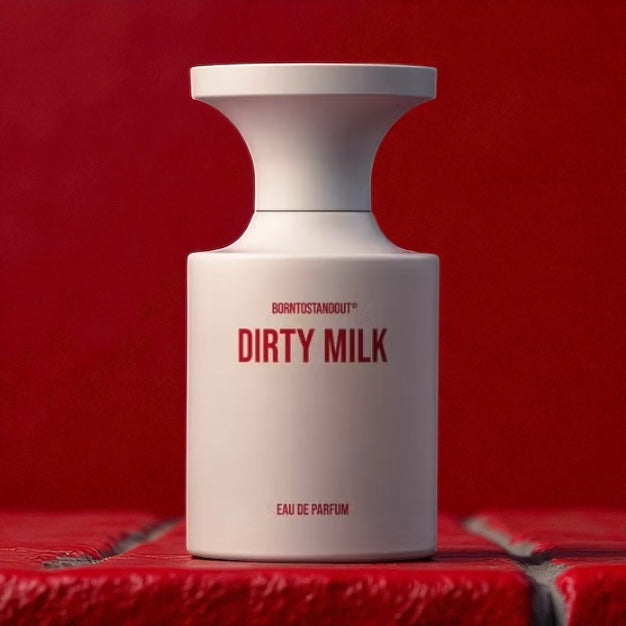 BORNTOSTANDOUT Dirty Milk perfume sample – creamy milk and caramel scent styled in a sensual red brick lifestyle setting.