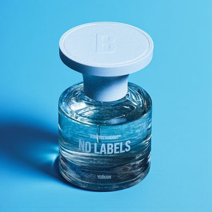 Borntostandout No Labels perfume sample styled in a warm atmospheric setting to reflect its rum, leather and YEONJUN inspired character.