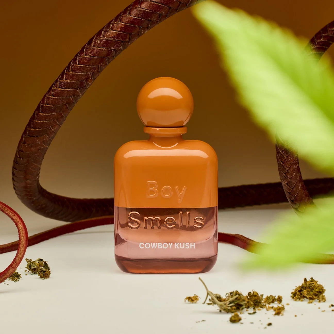 Boy Smells Cowboy Kush perfume styled in a rugged, smoky setting