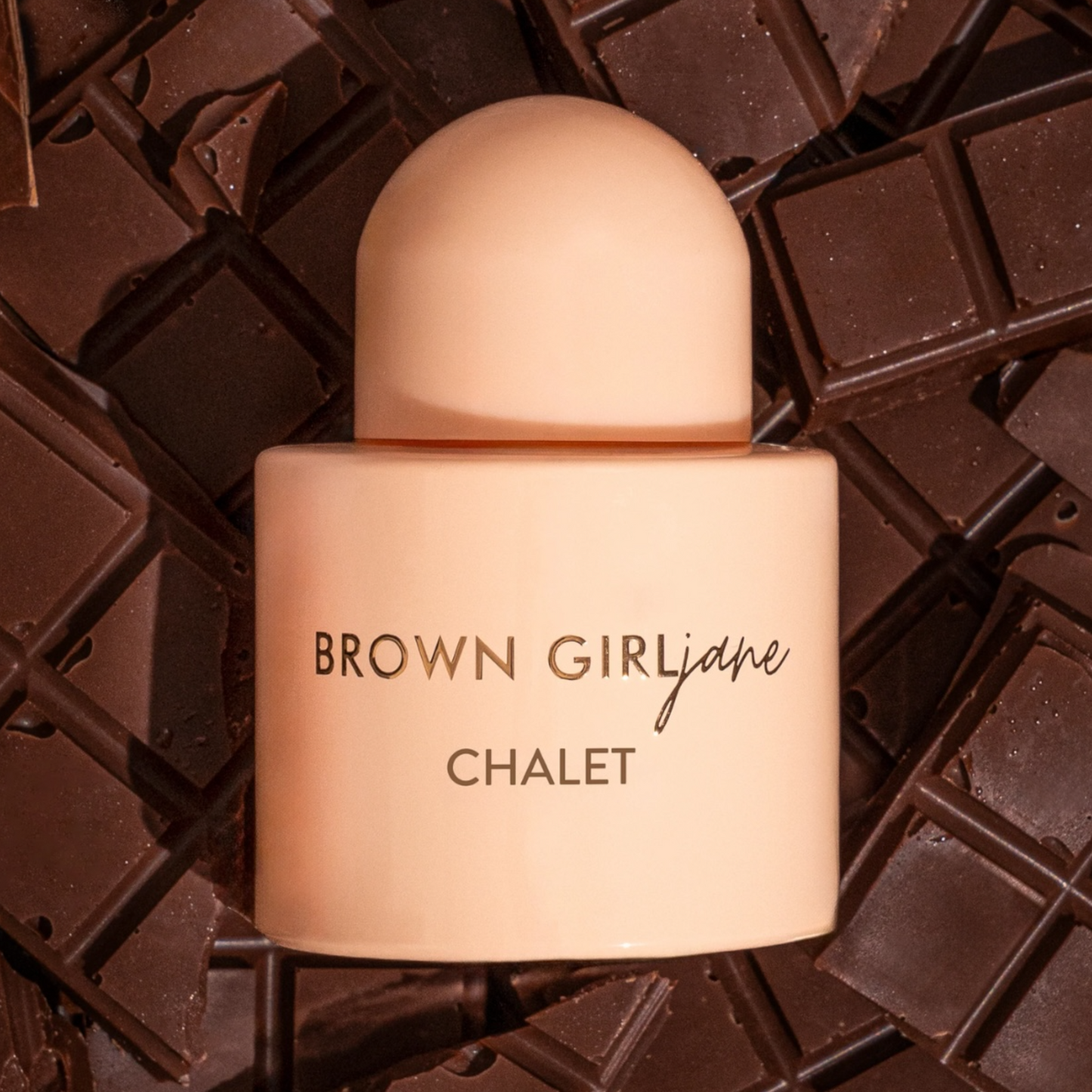 Brown Girl Jane Chalet perfume sample – dark cocoa, plum, and champagne notes styled in a sweet chocolate setting.