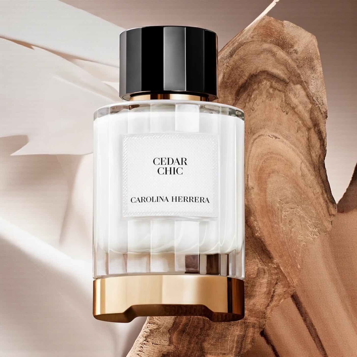 Carolina Herrera Cedar Chic perfume bottle on a wooden surface with clean cotton