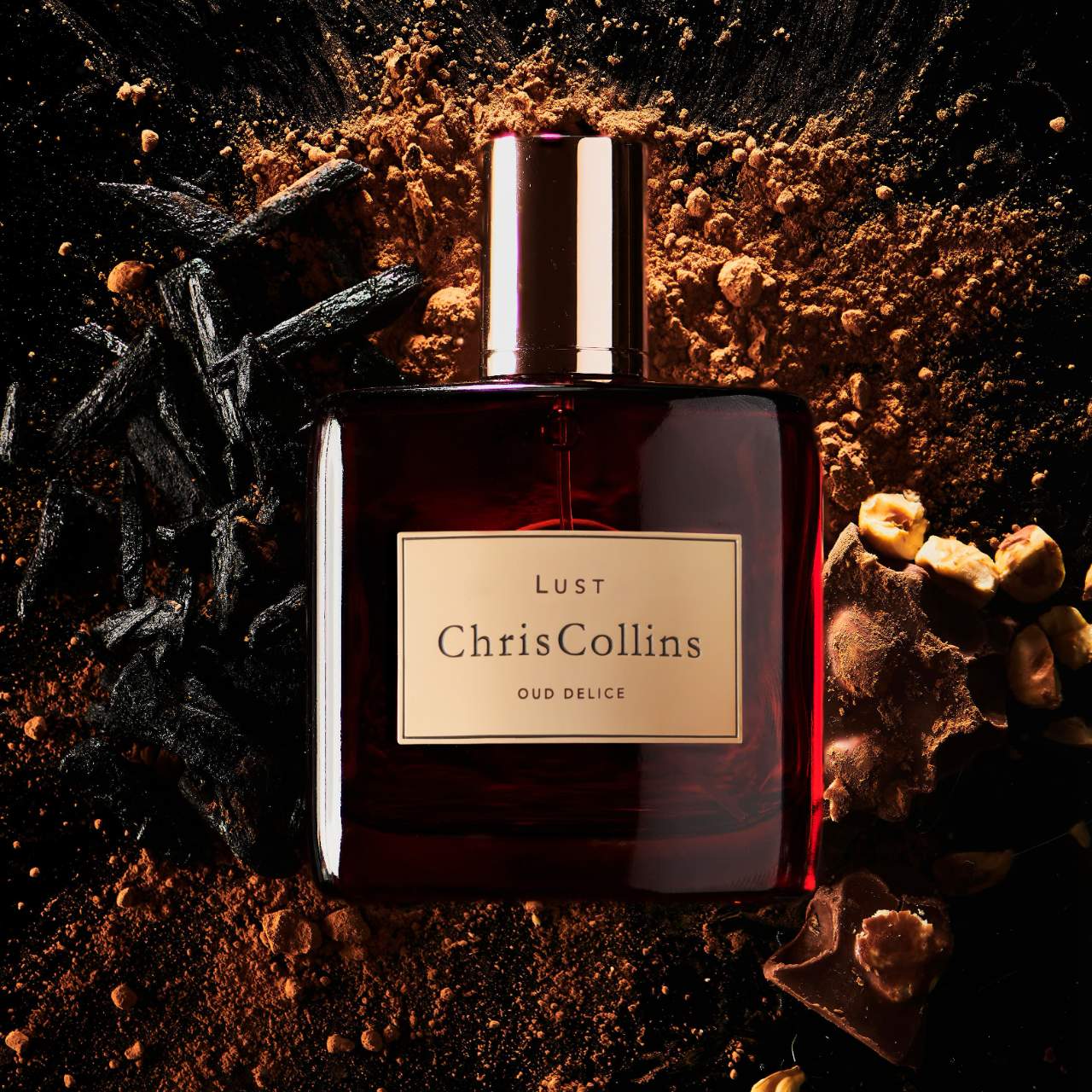 Chris Collins Lust Oud Délice perfume styled in a warm, gourmand setting