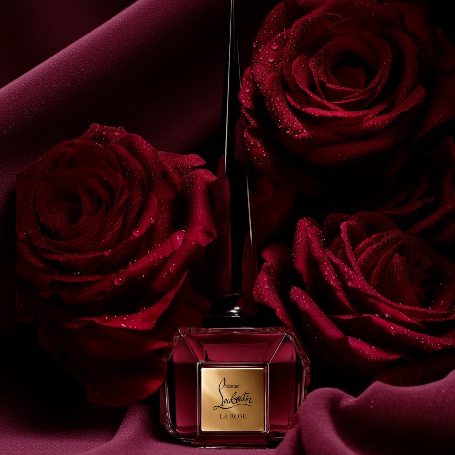 Christian Louboutin Fétiche La Rose perfume sample styled with deep red velvet and dark dewy red roses to reflect its seductive bold character.