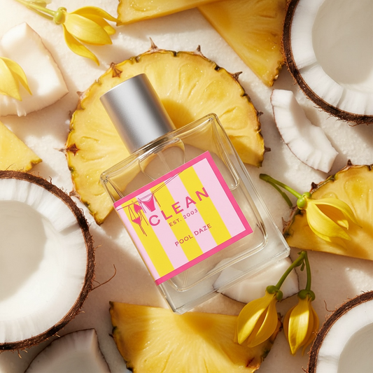 Clean Pool Daze perfume styled in a sunlit setting with pineapple and coconut