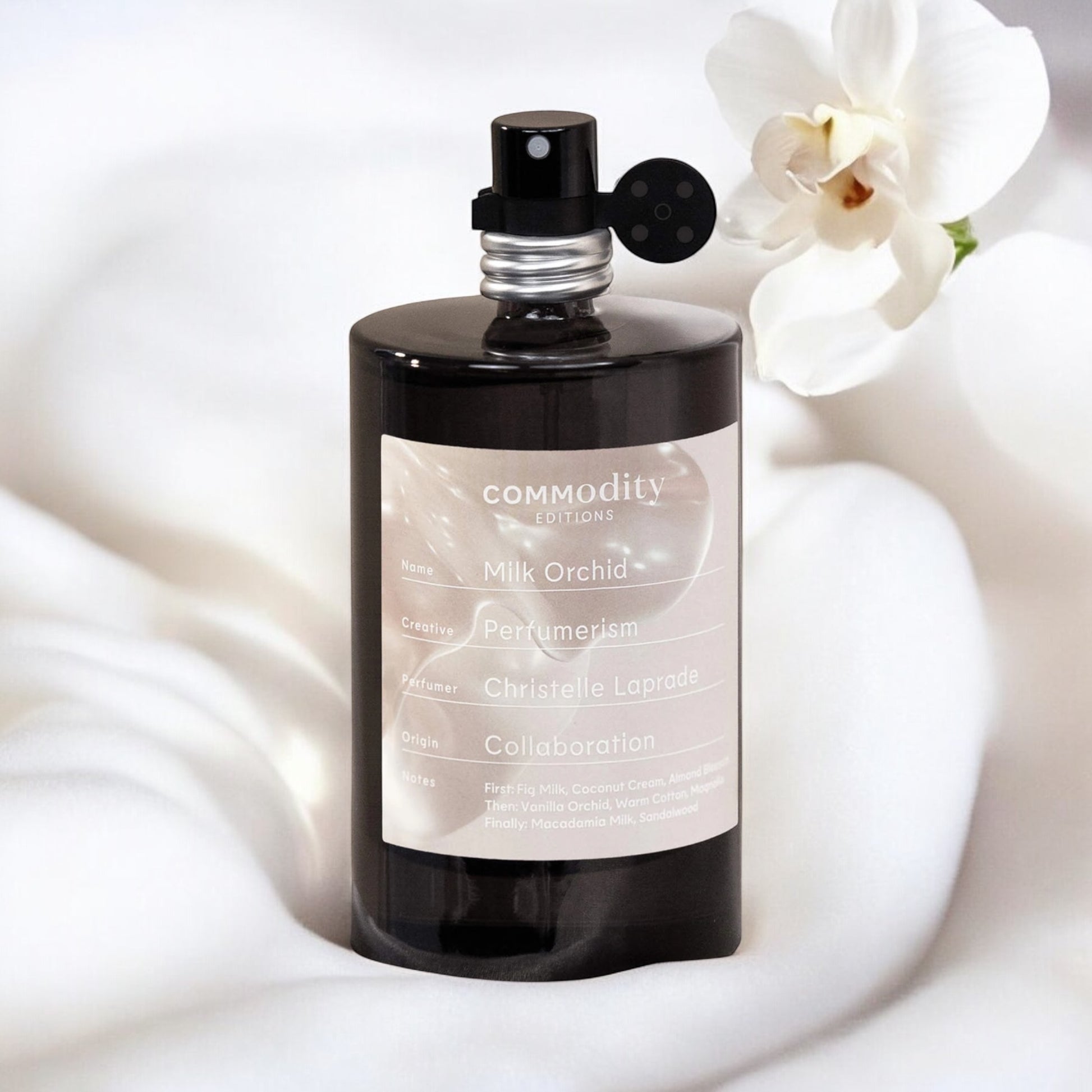 Commodity Milk Orchid perfume sample – creamy fig milk and vanilla orchid notes styled in a soft, minimalist setting.