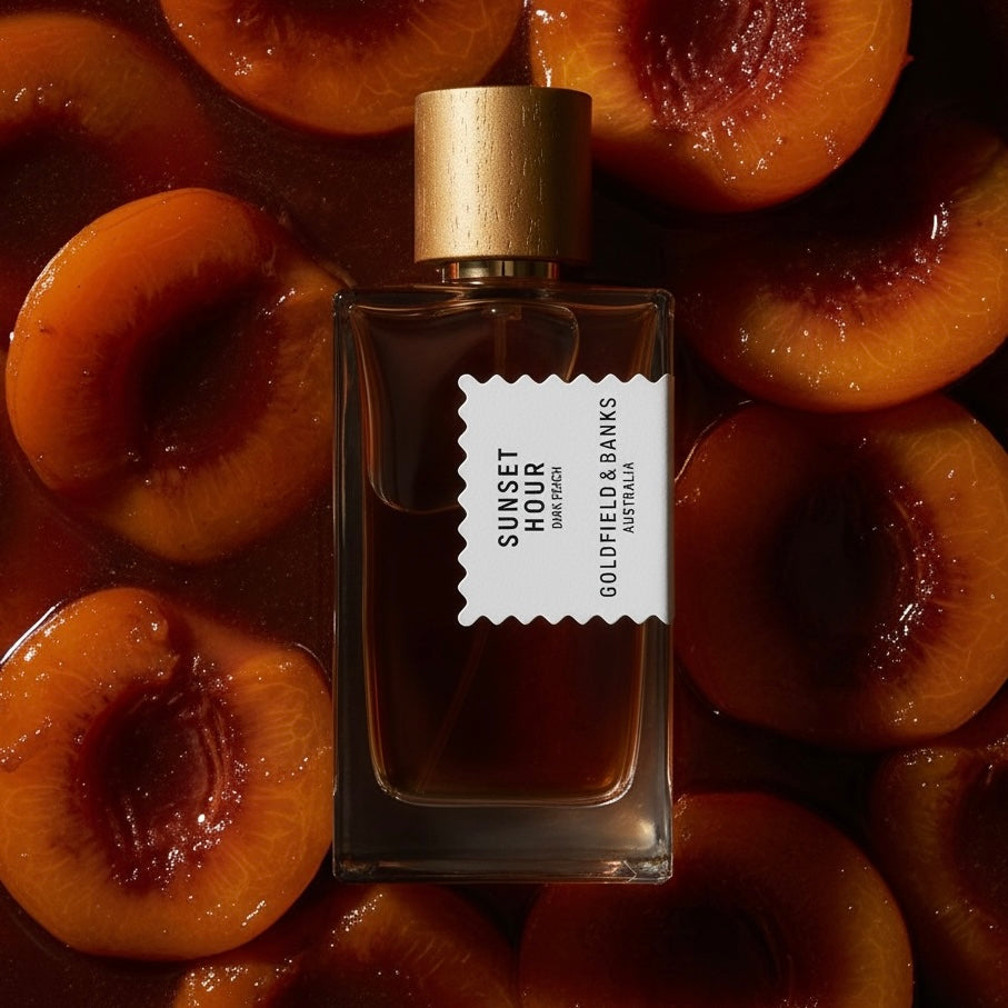 Goldfield & Banks Sunset Hour Dark Peach styled with dark peachhes soaked in Jamaican rum, in warm sunset light