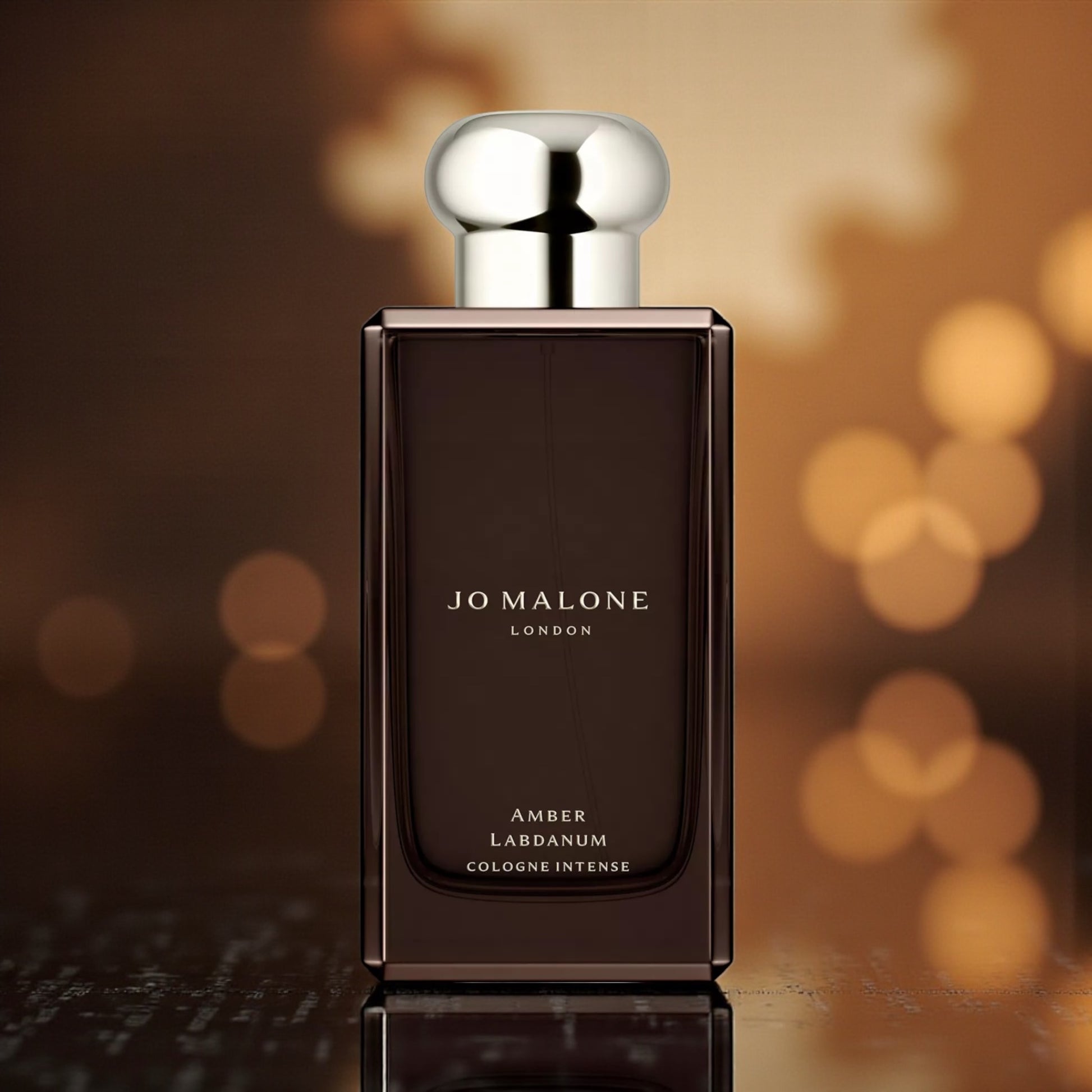 Jo Malone Amber Labdanum perfume styled in a warm, ambery setting