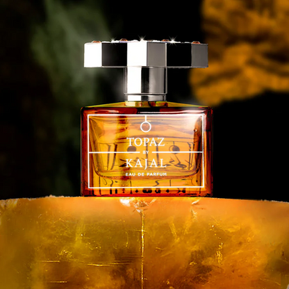Kajal Topaz perfume sample – luminous citrus, cassis and amber woods in a radiant gemstone-inspired setting.