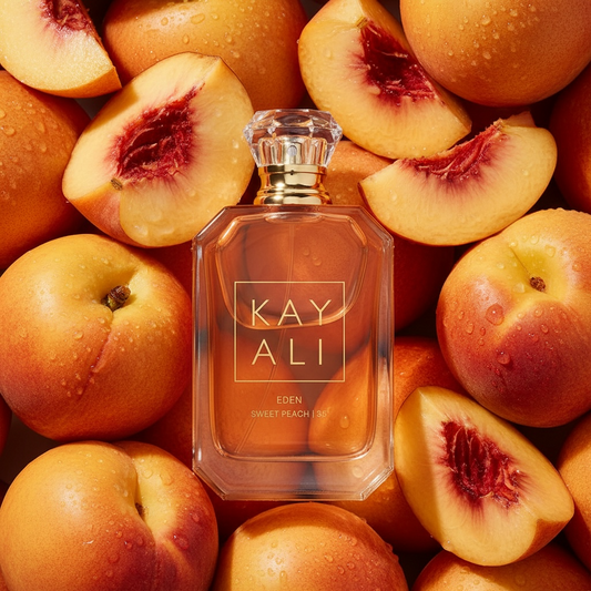 Kayali Eden Sweet Peach 35 perfume styled with ripe peaches