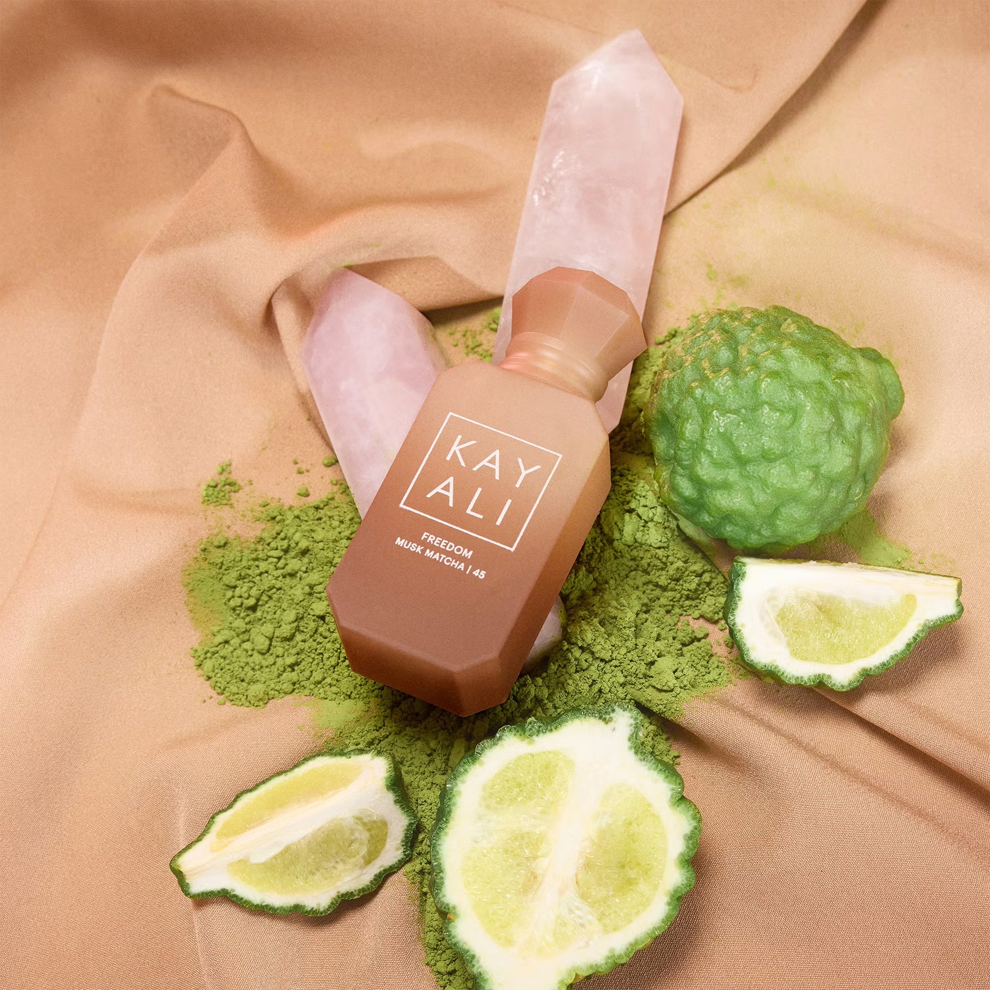 Kayali Freedom Musk Matcha 45 perfume sample styled in a soft grounding setting to highlight its matcha, oat milk and sweet musk notes.