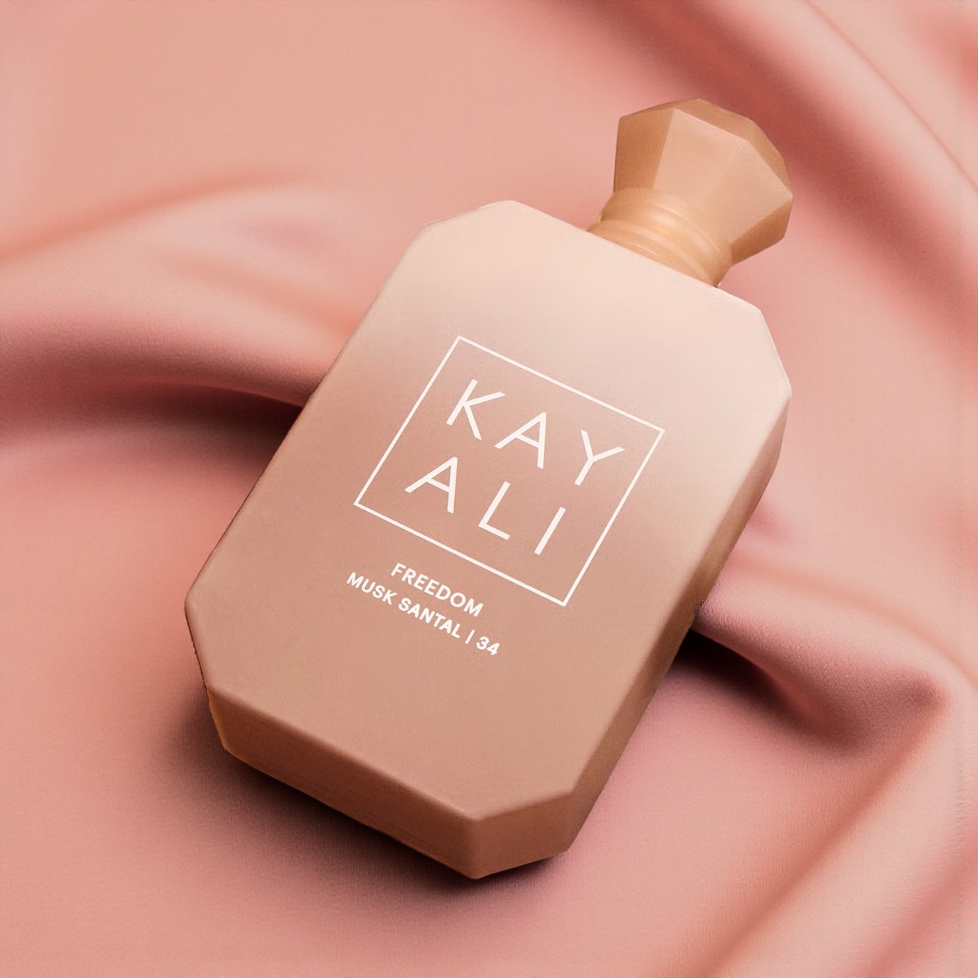 Kayali Freedom Musk Santal 34 perfume sample styled in a soft warm setting to highlight its freesia, amber and sandalwood notes.