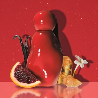 Kylie Jenner Cosmic Intense perfume styled in a warm, glowing setting