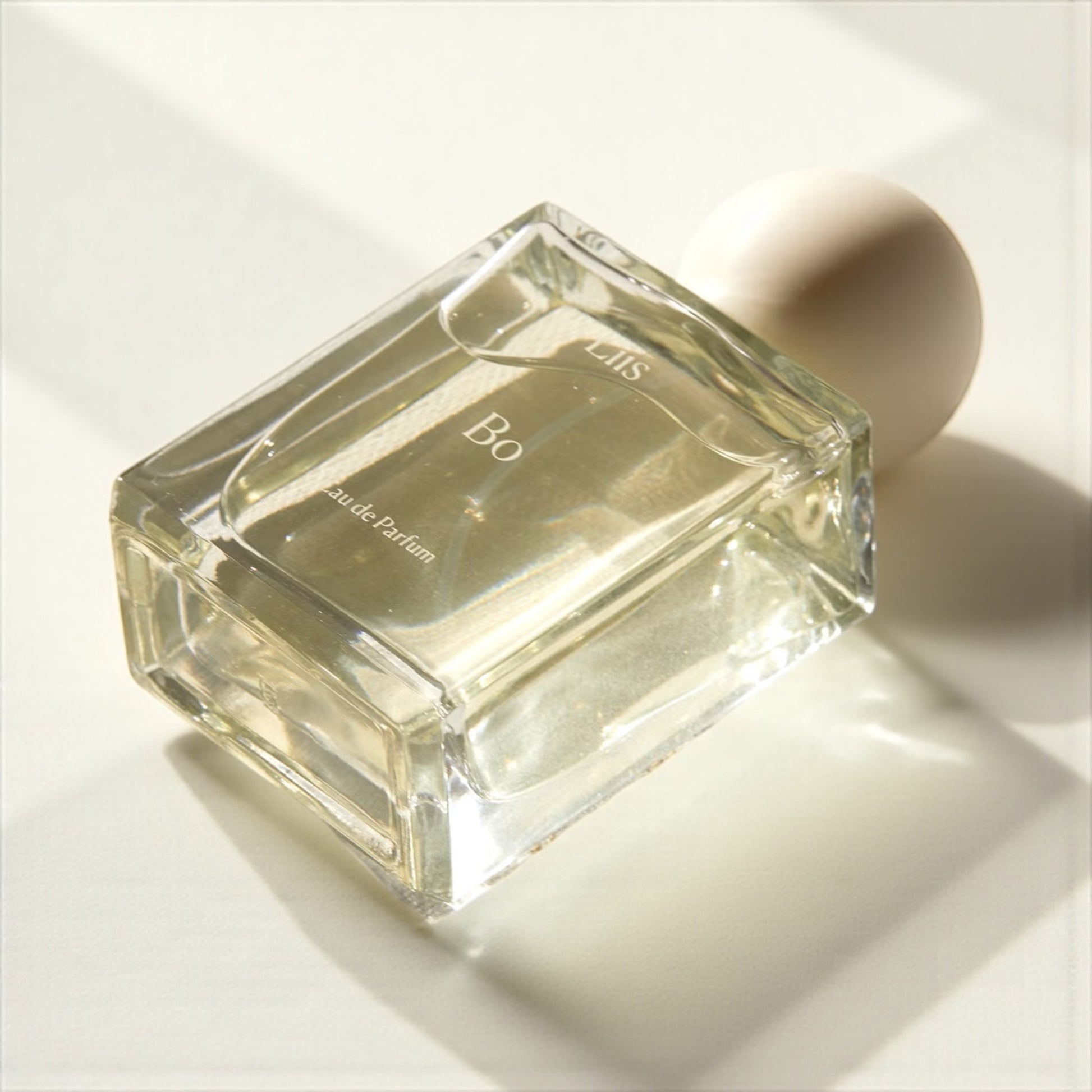 Liis Bo perfume sample – incense, tobacco, and smoky pine notes styled in a warm, coastal forest-inspired setting.