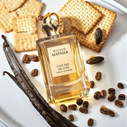 Maison Mataha Café des Délices perfume bottle styled with coffee beans, biscuits and vanilla pods.