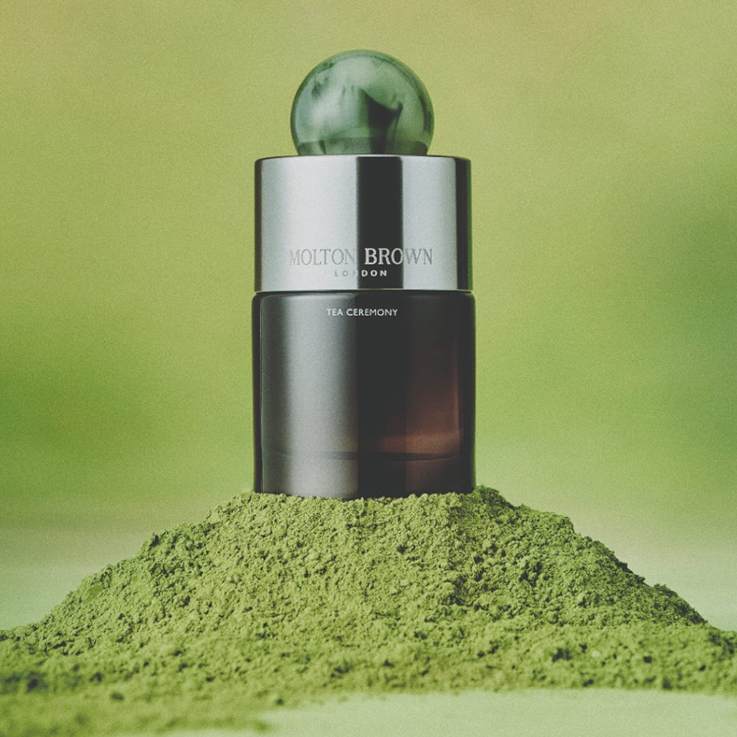 Molton Brown Tea Ceremony perfume styled with green matcha powder