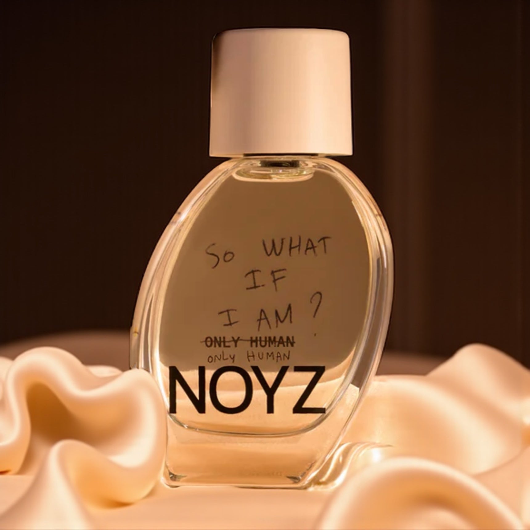 Noyz Only Human perfume sample – warm vanilla, ambroxan, and cedarwood notes styled in a soft, neutral-toned setting.