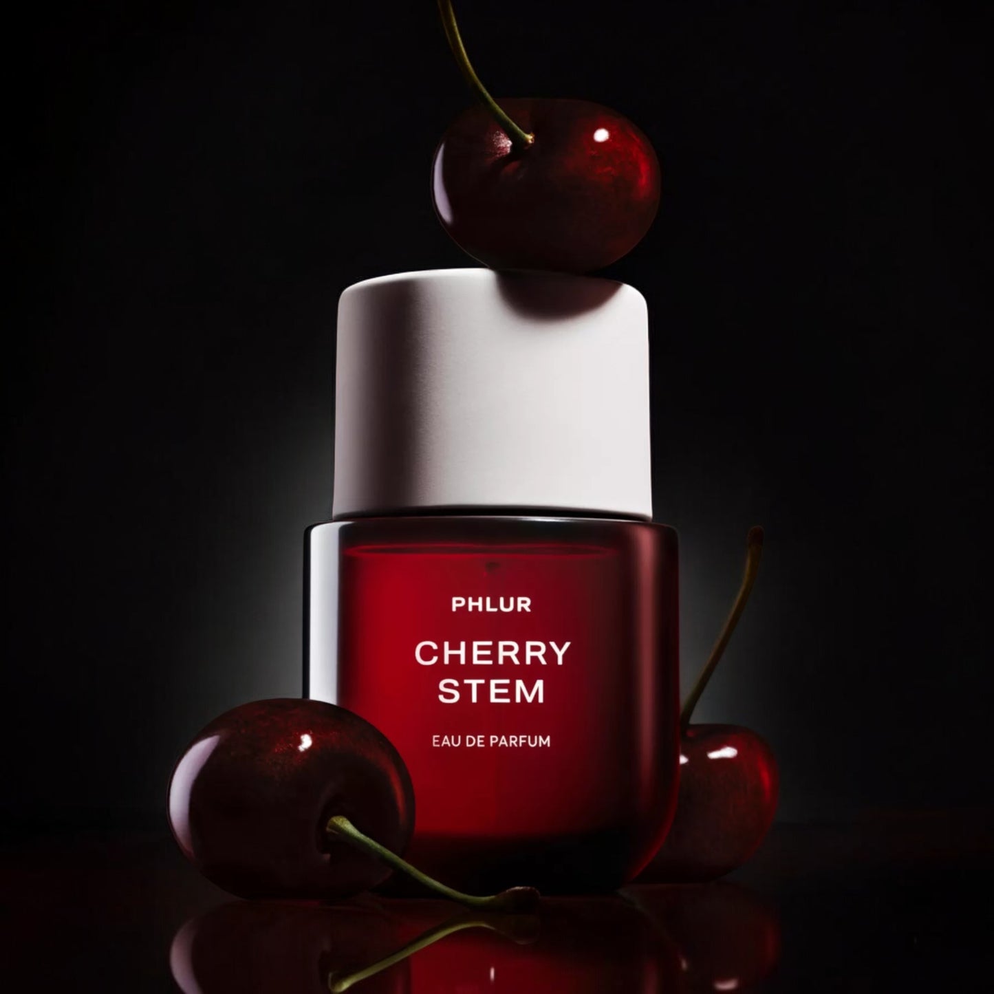Phlur Cherry Stem perfume sample – dark cherry and warm woods styled in a sultry evening setting.